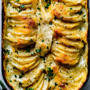 Creamy scalloped potatoes baked to perfection with layers of cheese and herbs