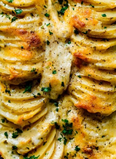 Creamy scalloped potatoes baked to perfection with layers of cheese and herbs