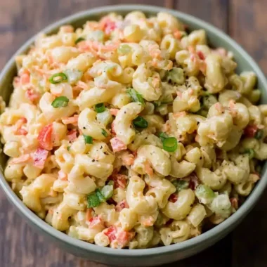 Delicious small homemade macaroni salad in a bowl with fresh ingredients