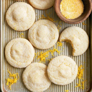 Soft and chewy lemon cookies on a plate with lemon slices