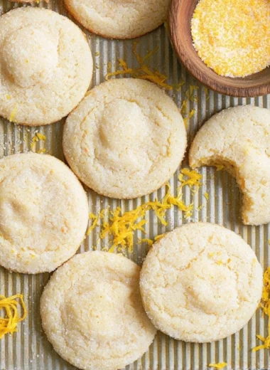 Soft and chewy lemon cookies on a plate with lemon slices
