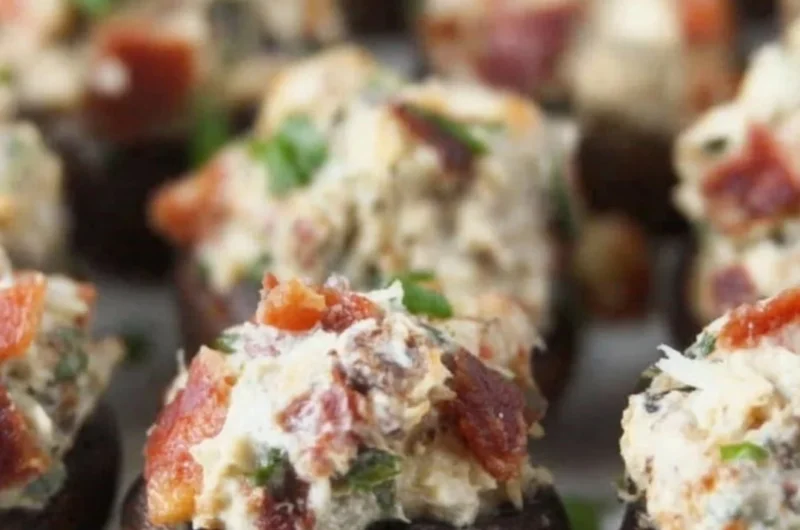 Stuffed mushrooms with bacon and cream cheese garnished with green onions.