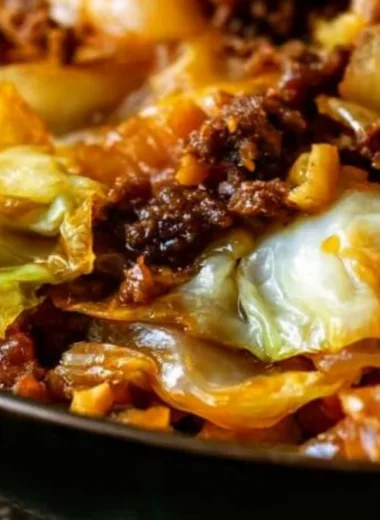 Cabbage and ground beef dish served in a bowl, garnished with herbs.