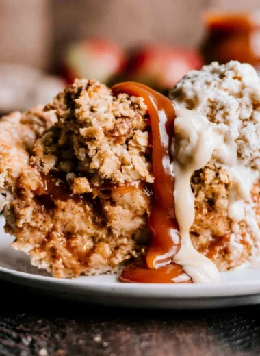 Slice of Dutch Caramel Apple Pie with warm caramel drizzle
