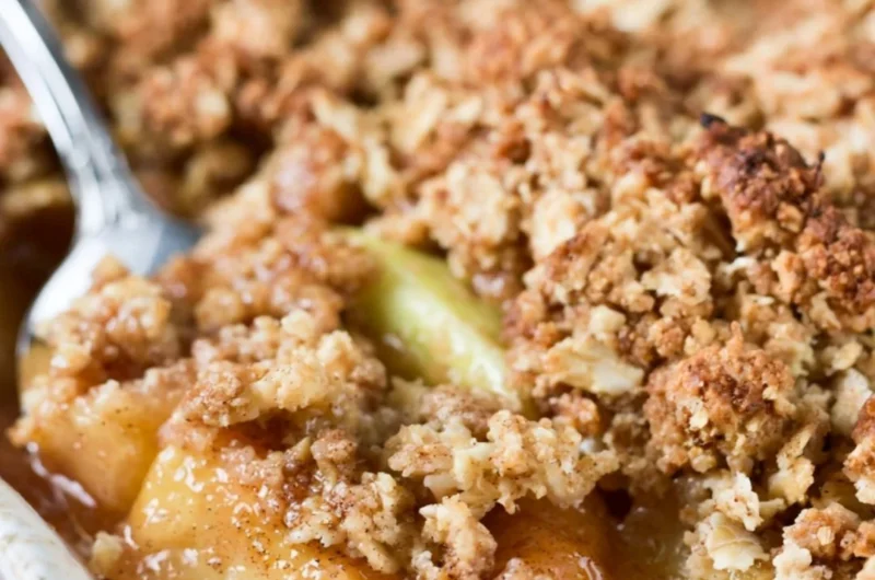 Bowl of easy apple crisp topped with oats perfect for Thanksgiving desserts