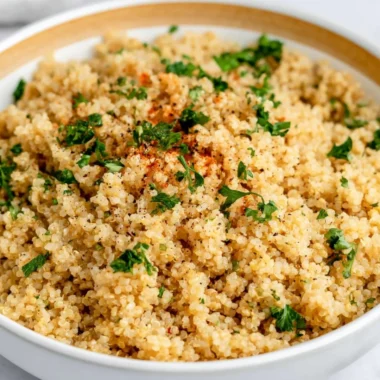 Delicious Garlic Butter Quinoa served in a bowl, garnished with herbs.