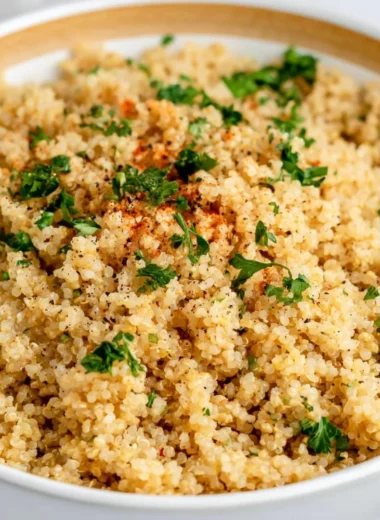 Delicious Garlic Butter Quinoa served in a bowl, garnished with herbs.