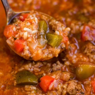 Bowl of delicious Instant Pot stuffed pepper soup garnished with fresh herbs.
