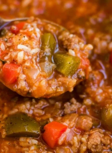 Bowl of delicious Instant Pot stuffed pepper soup garnished with fresh herbs.