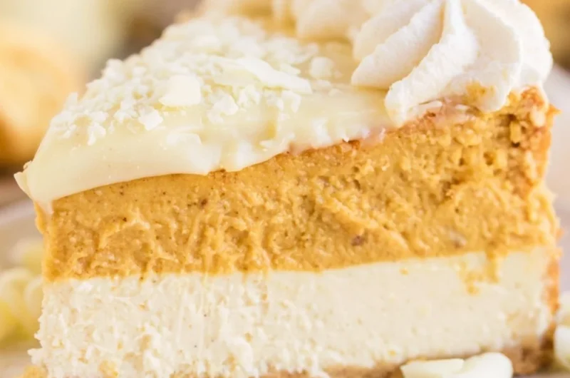 Delicious Eggnog Pumpkin Cheesecake topped with whipped cream and spices