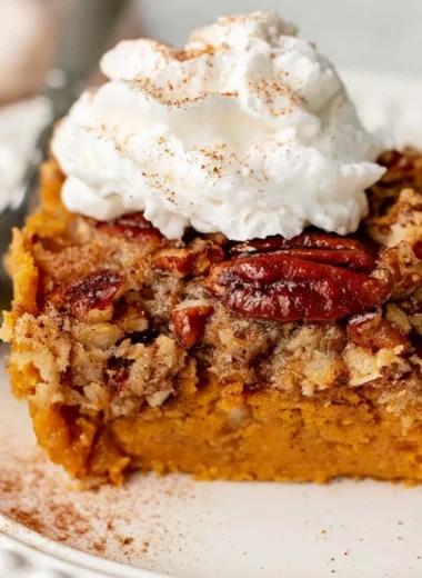 Delicious Pumpkin Dump Cake served with whipped cream on a plate