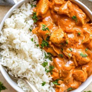 A delicious Coconut Chicken Rice Bowl topped with fresh herbs and vegetables.