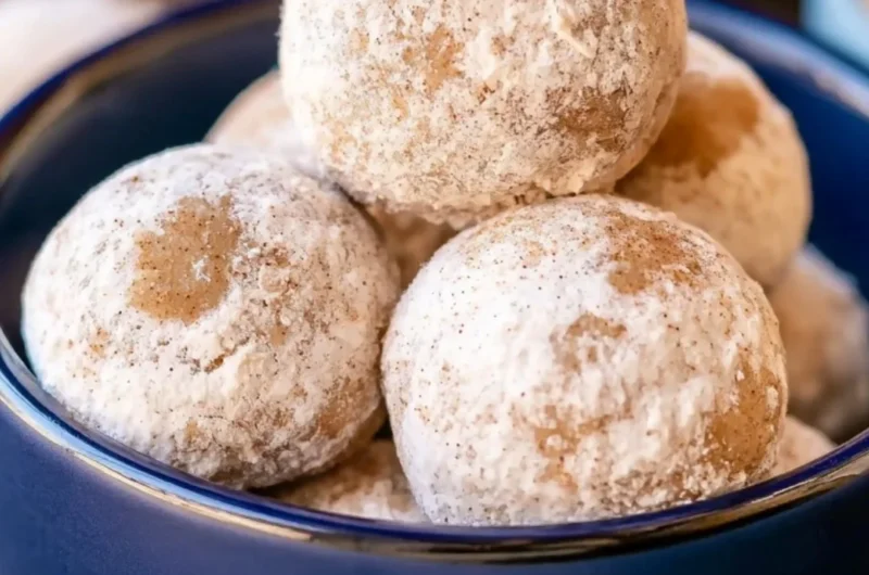 Plate of delicious Gingerbread Snowball Cookies dusted with powdered sugar